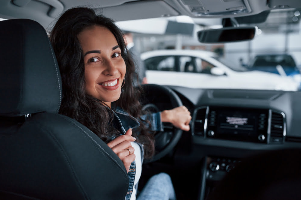 moving backwards ute girl with black hair trying her brand new expensive car automobile salon