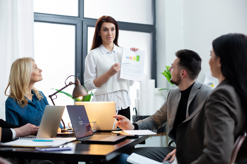 Itens para Escritório: Ambiente de Trabalho Produtivo 4 pessoas de tiro medio trabalhando juntas no escritorio